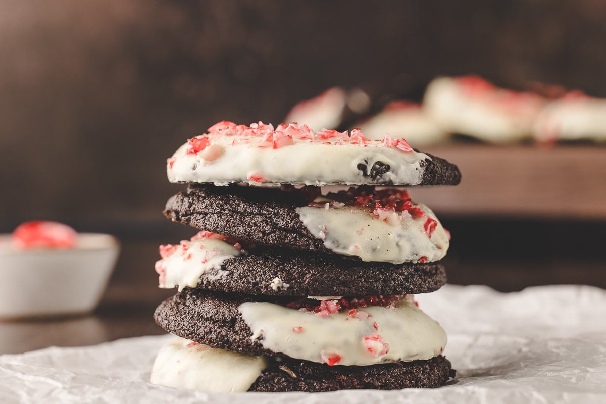 Five chocolate candy cane cookies in a stack. 