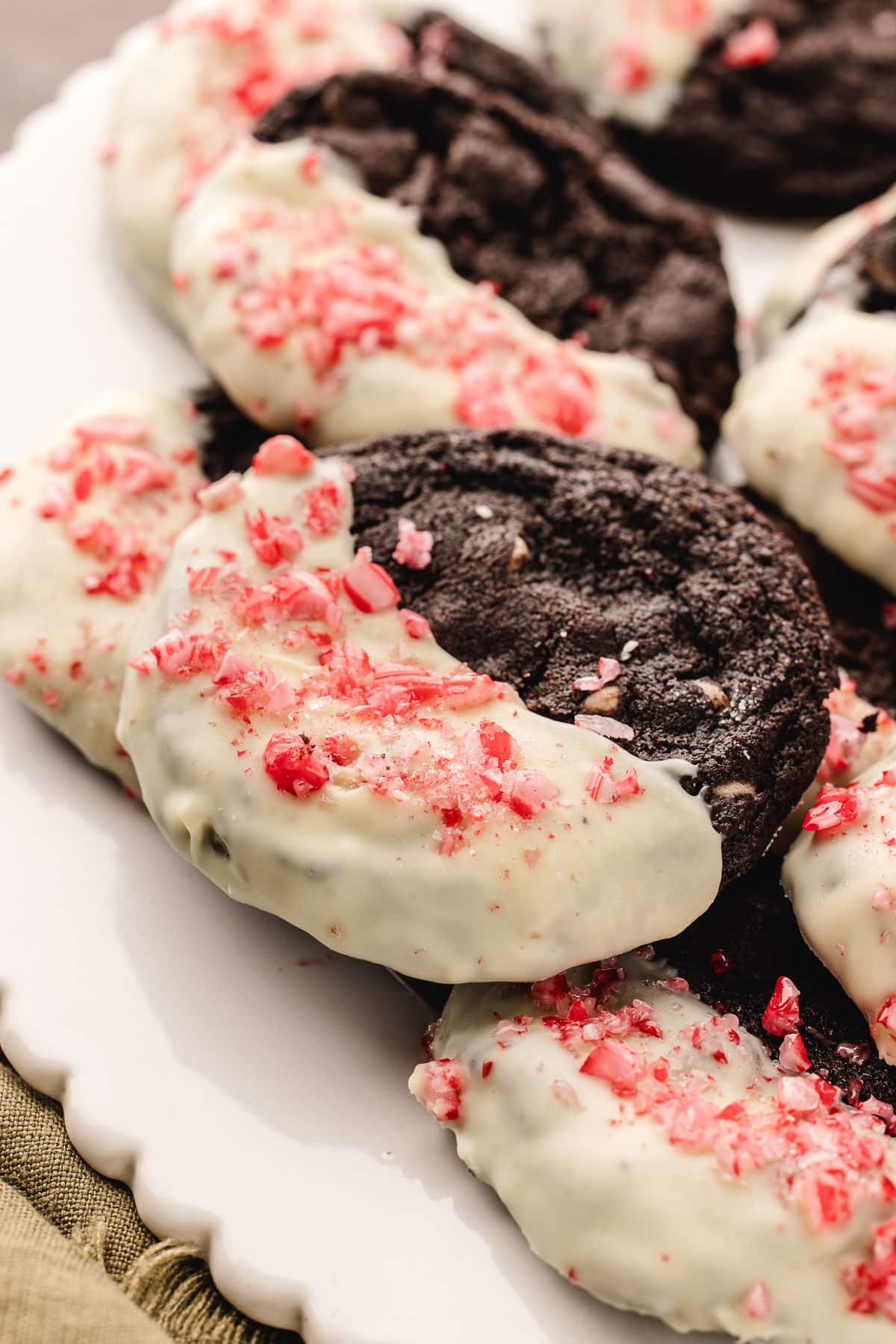 A platter of overlapping chocolate candy cane cookies.