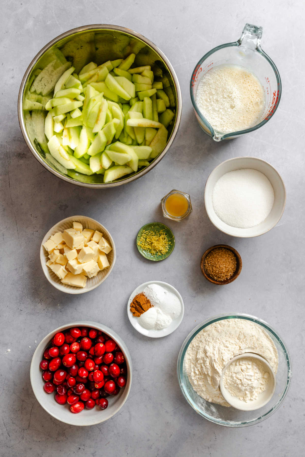Ingredients for cranberry apple cobbler in dishes.