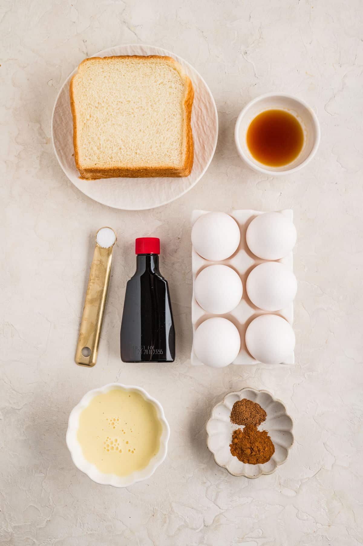 Ingredients for eggnog French toast in dishes.