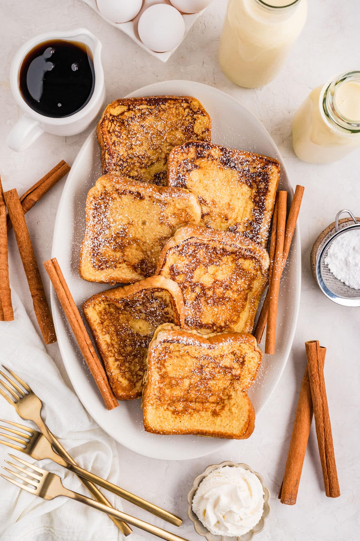 A platter of eggnog French toast dusted with powdered sugar.
