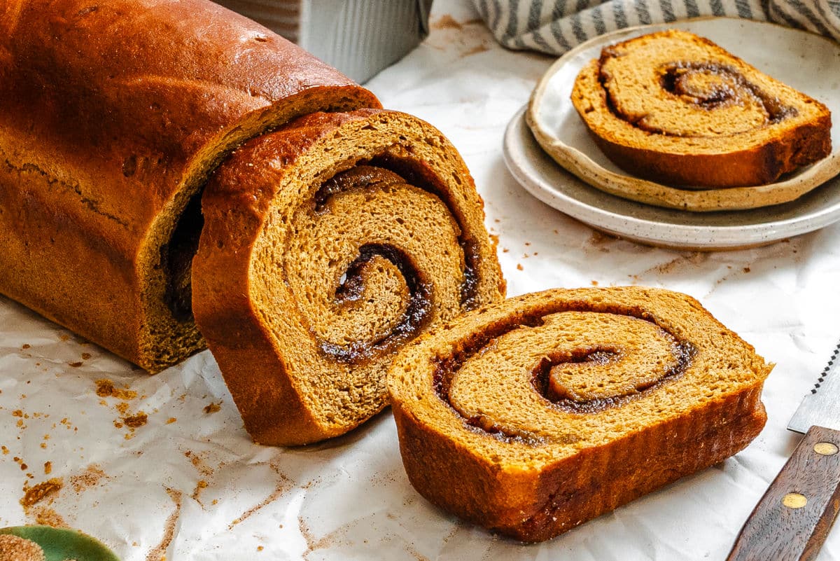Slices of gingerbread cinnamon bread leaning against the loaf. 