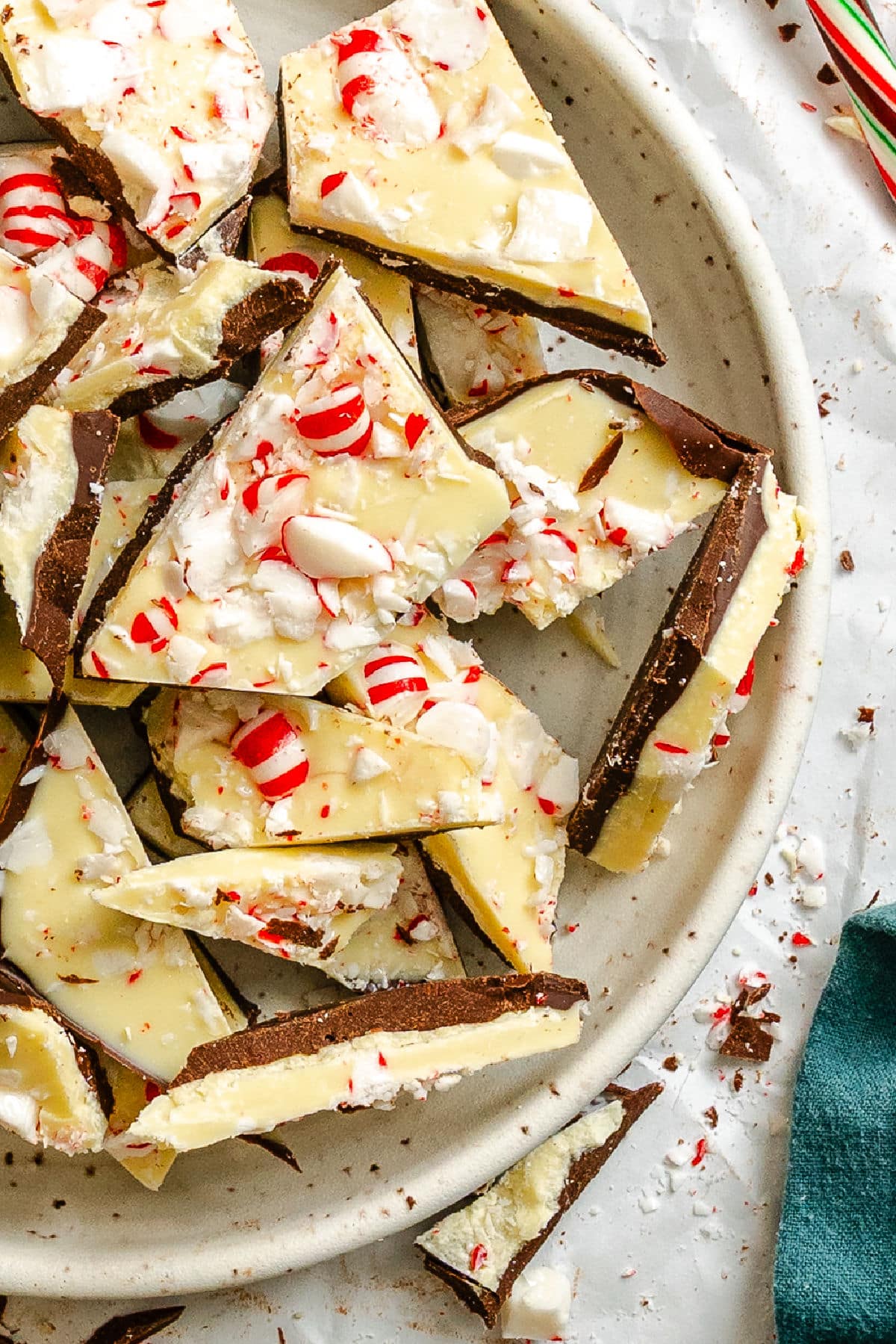 Overlapping pieces of homemade peppermint bark in a plate. 