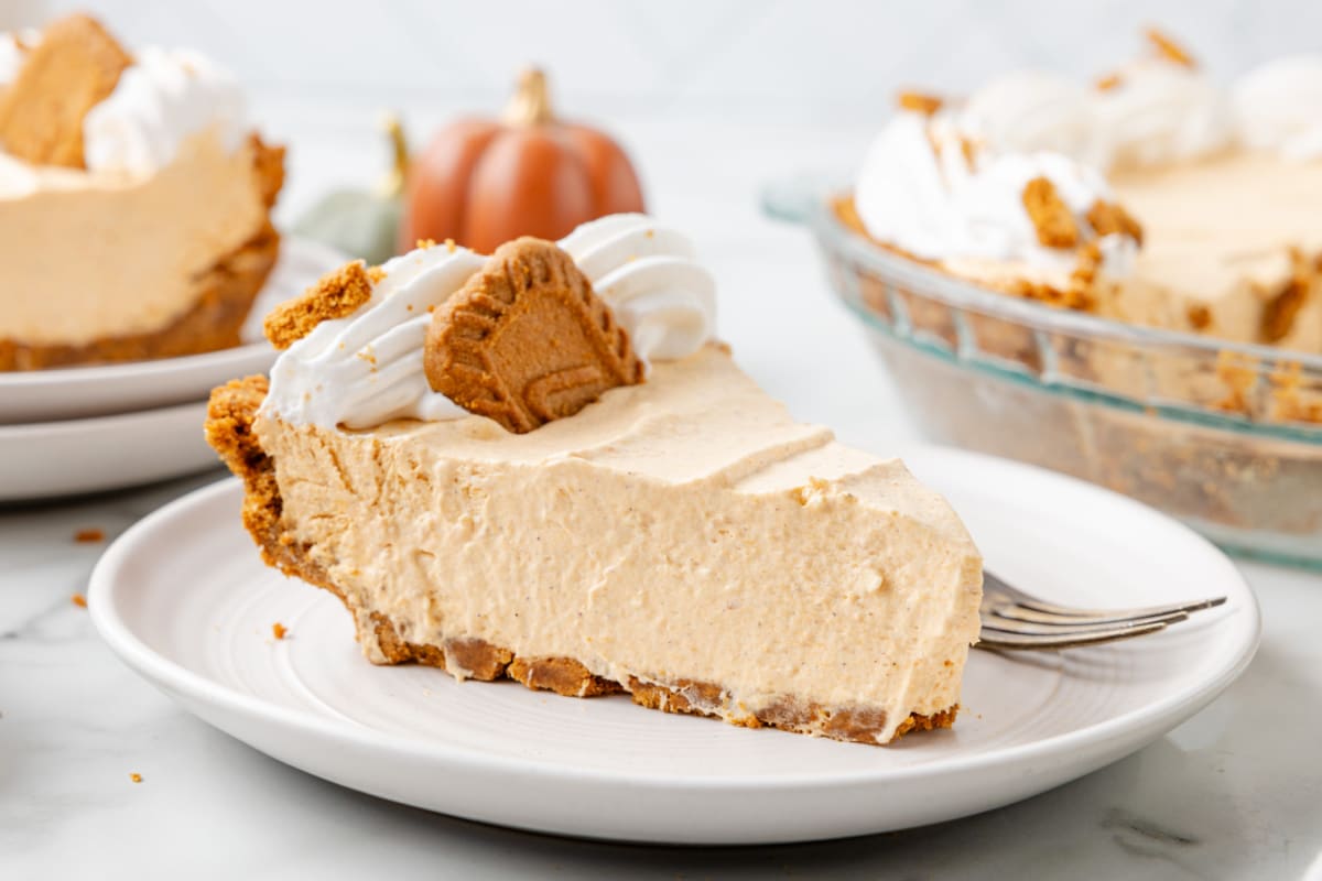 Slices of no bake pumpkin pie on white plates.