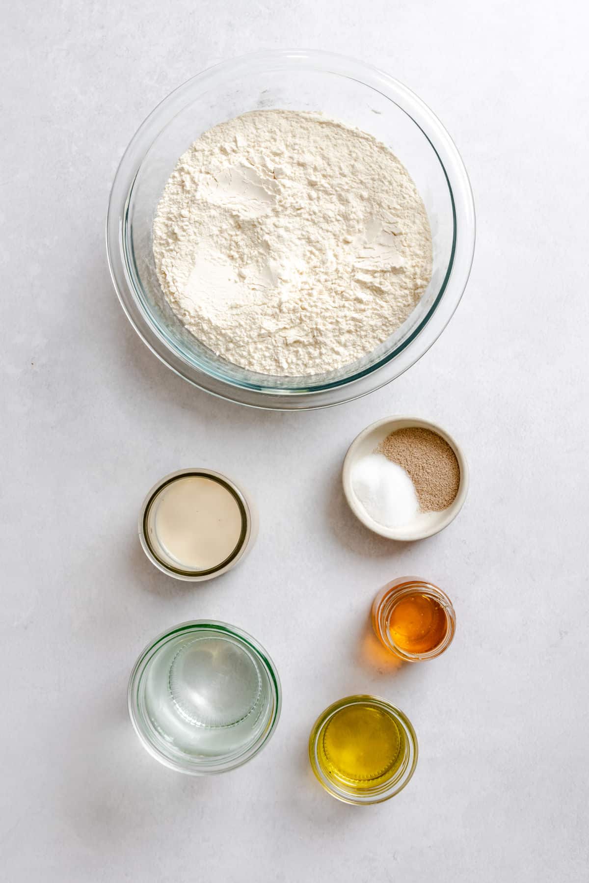 Ingredients for bread machine honey oat bread in dishes.