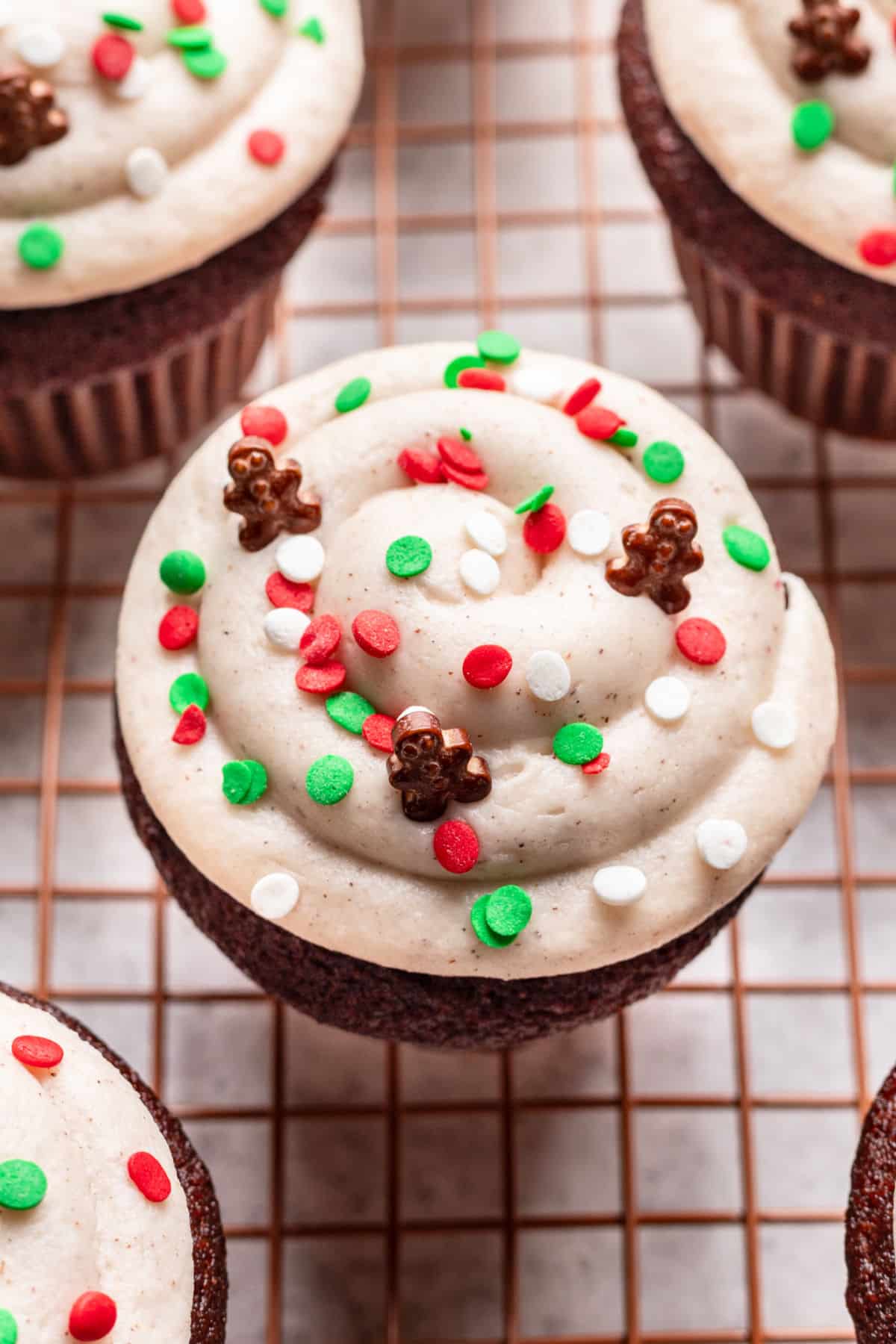 A close up picture of the frosted and decorations on a gingerbread cupcake. 