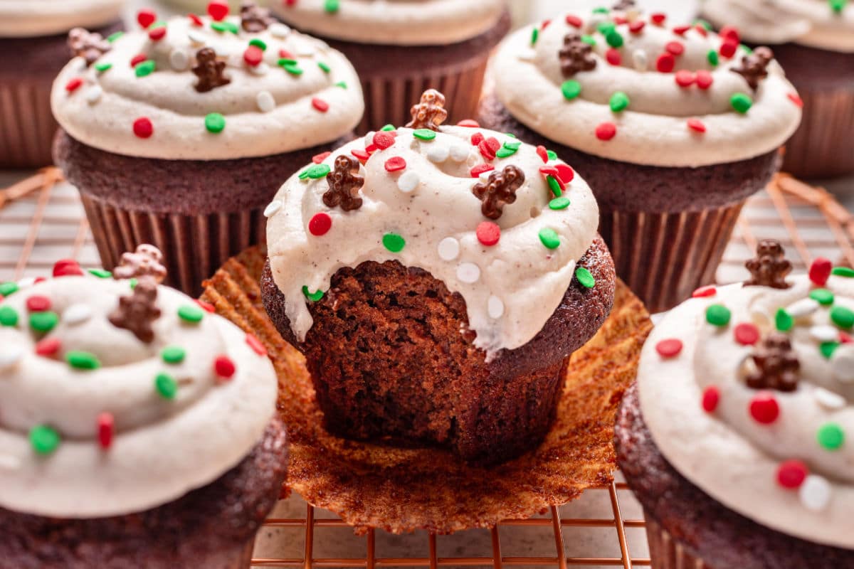 A gingerbread cupcake with a bite missing out of it. 