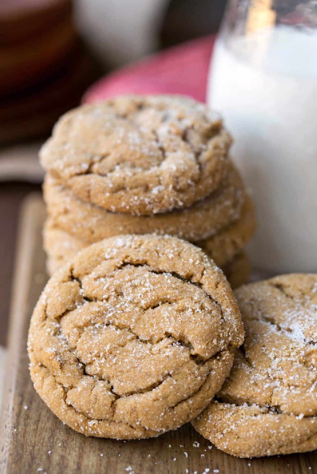 A stack of soft molasses cookies next to a bottle of milk. 