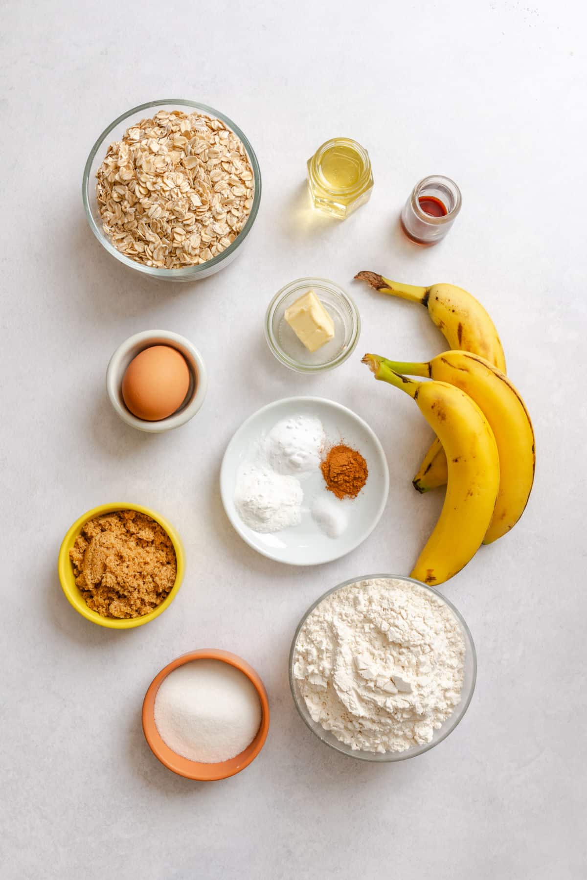 Ingredients for banana oatmeal muffins in dishes.