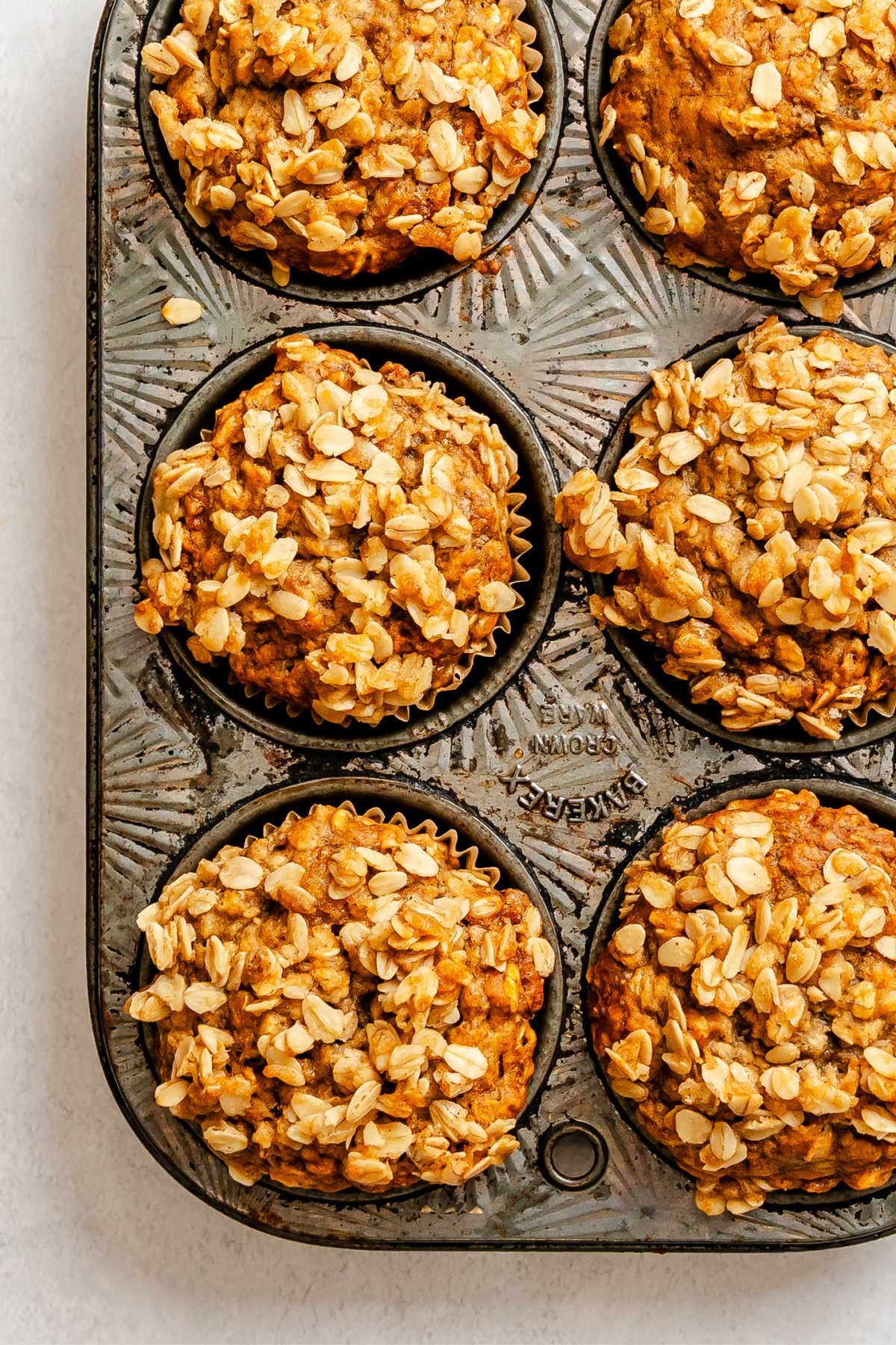 Baked banana oatmeal muffins in a muffin tin.