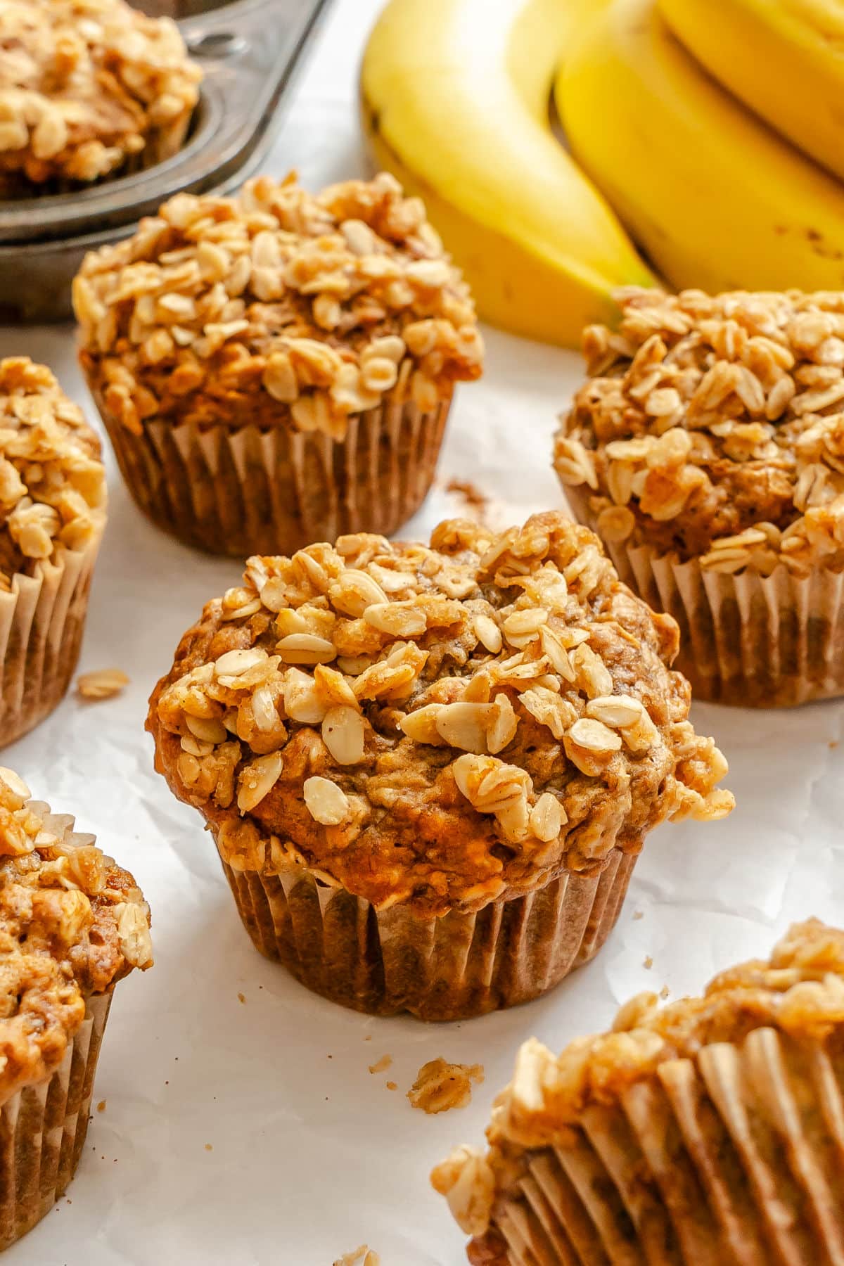 Banana Oatmeal Muffins Banana oatmeal muffins next to a bunch of bananas.