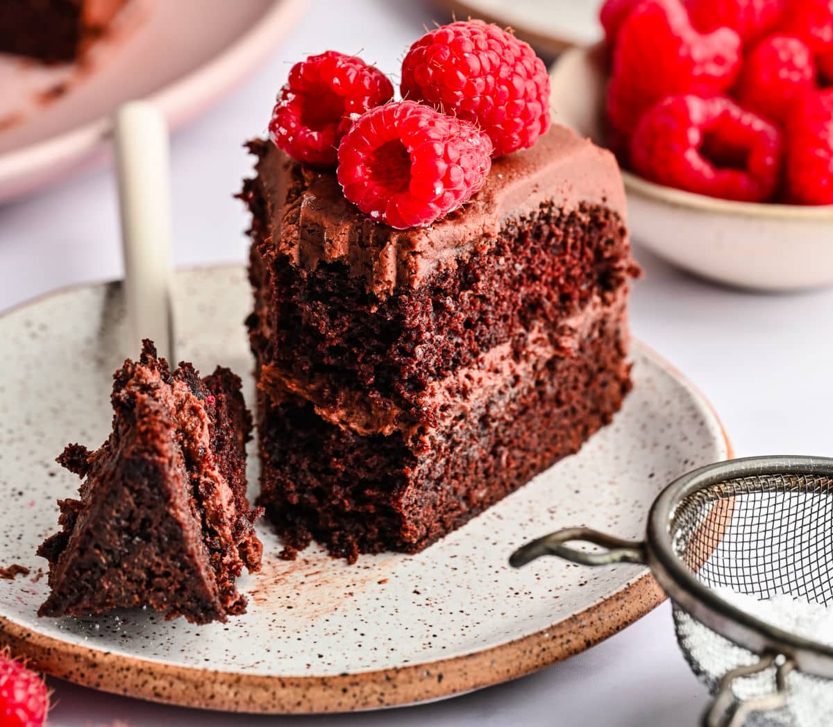 Chocolate Brownie Cake A piece of brownie cake with a bite on the fork next to the slice.