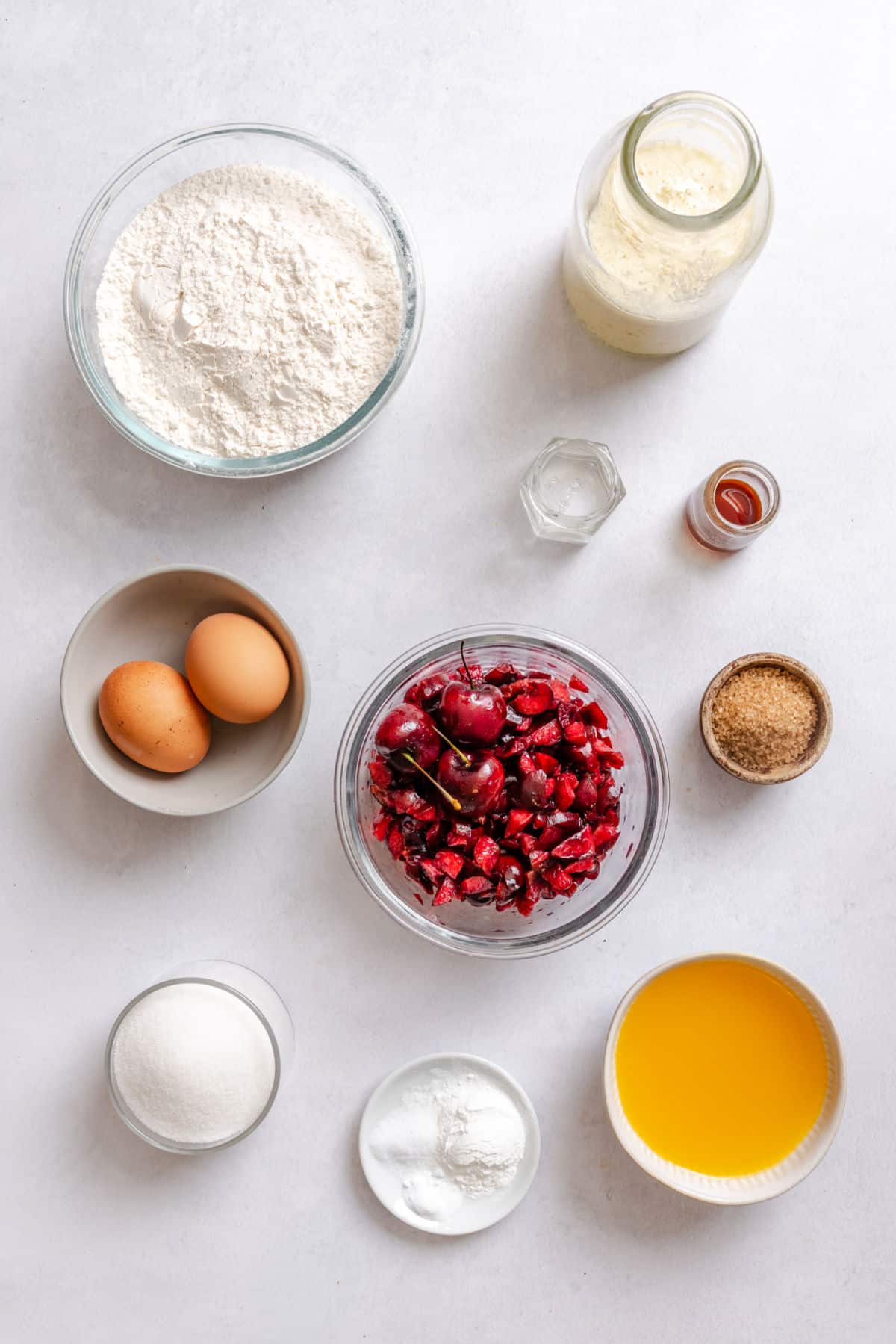 Ingredients for cherry muffins in dishes.