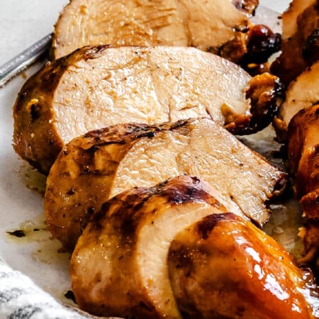 Sliced brown sugar bourbon marinated chicken on a plate.