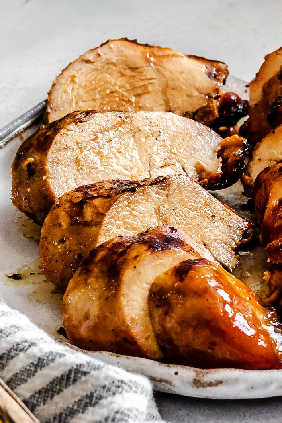Sliced brown sugar bourbon marinated chicken on a plate.