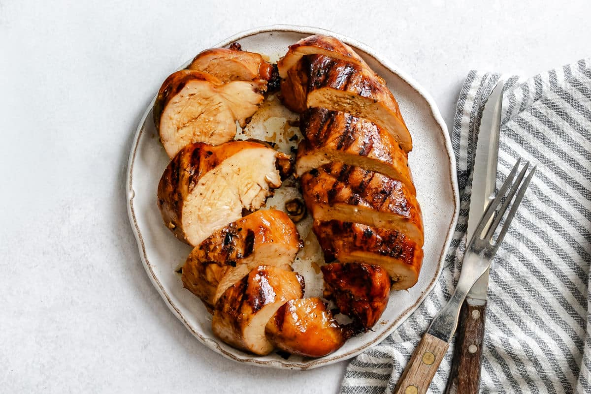 Two grilled pieces of chicken that were marinated in brown sugar bourbon chicken marinade. 