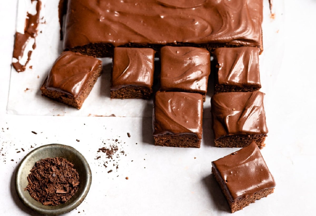 Cut frosted brownies next to the rest of the pan of brownies. 