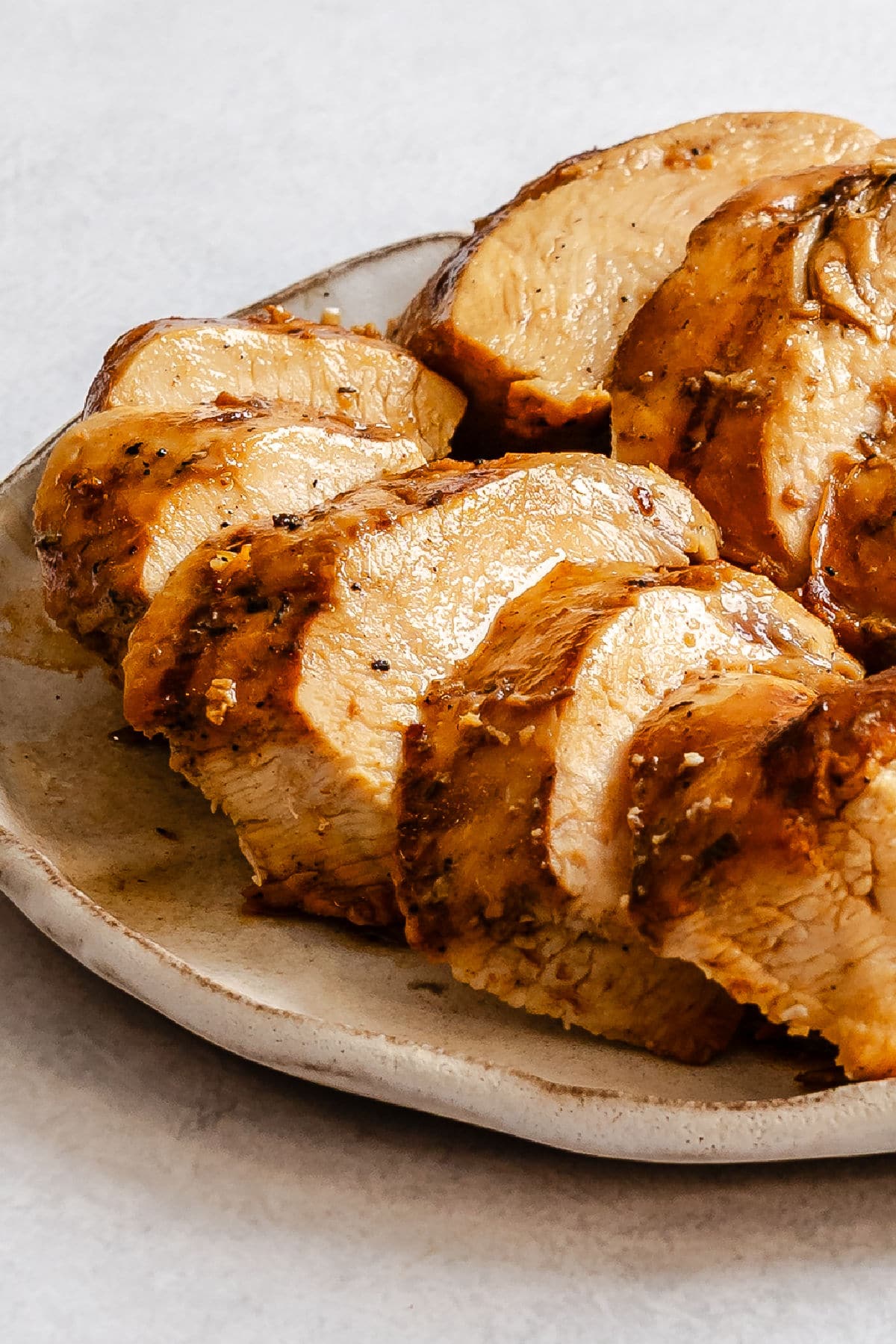 Sliced grilled Margarita-marinated chicken on a plate.