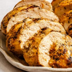 Mustard herb marinaded grilled chicken on a plate.