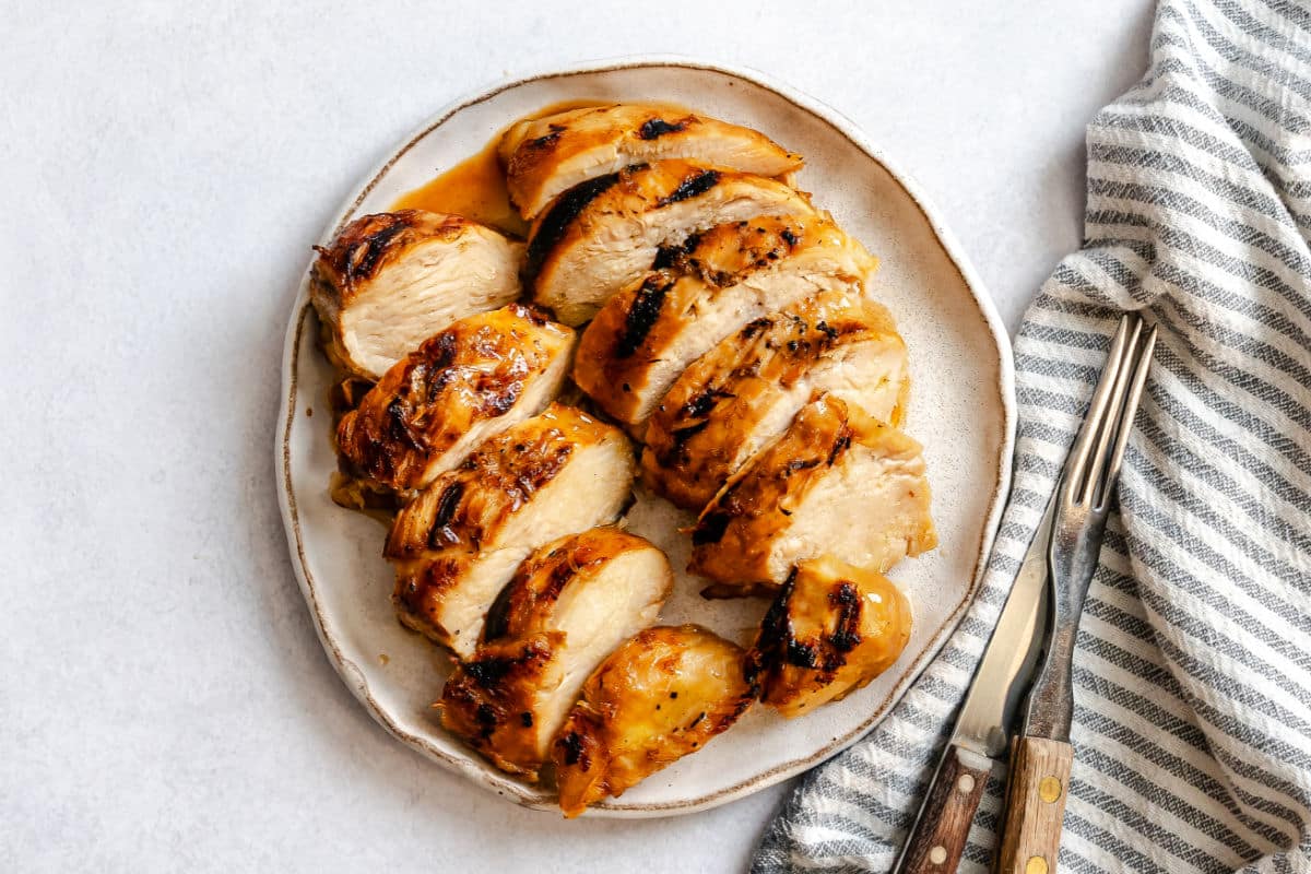 Two grilled tequila lime marinated chicken breasts on a plate.