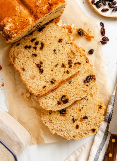 Three slices of bread machine Irish soda bread next to the loaf.