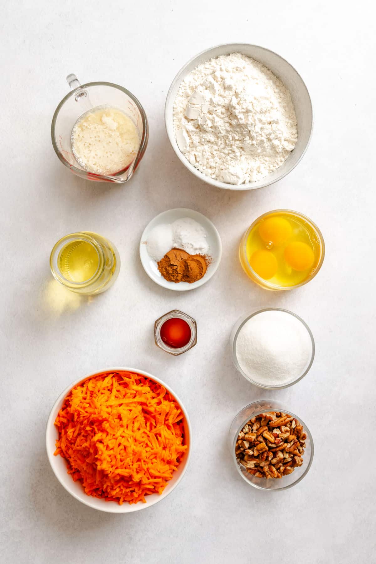 Ingredients for carrot loaf cake in dishes.