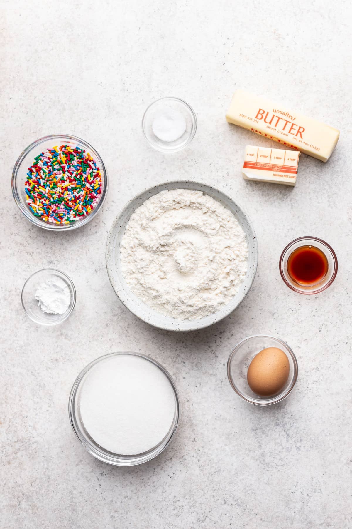 Ingredients for sprinkle cookies in dishes.