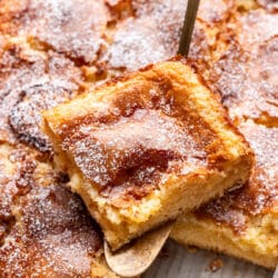 A slice of gooey butter cake on a cake server.