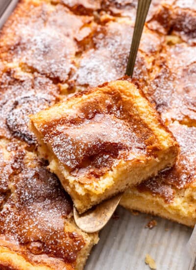 A slice of gooey butter cake on a cake server.