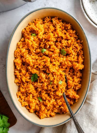 A dish of Instant Pot Mexican rice with a spoon in it.