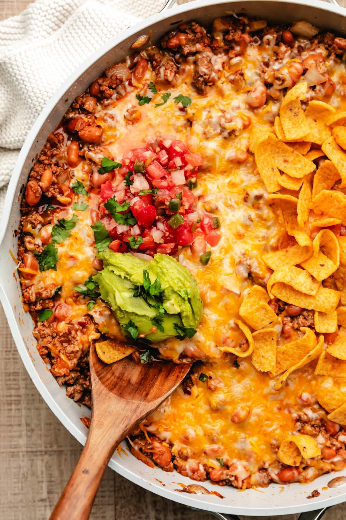 A wooden spoon in a taco skillet pan. 