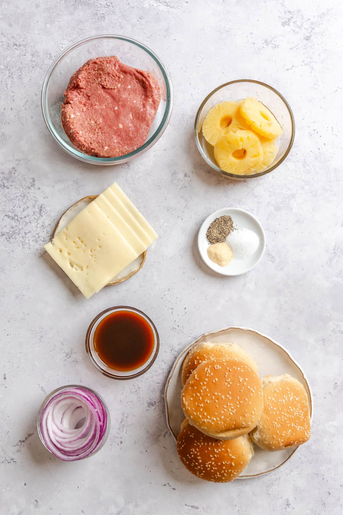 Ingredients for aloha burgers in dishes.