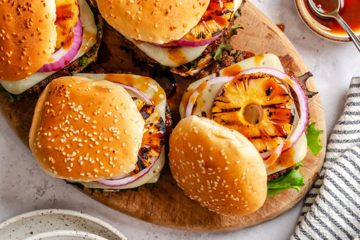 An aloha burger with the bun askew next to more aloha burgers.