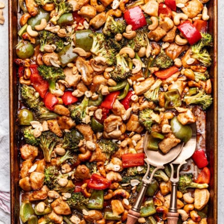 Sheet pan cashew chicken with two forks in it.