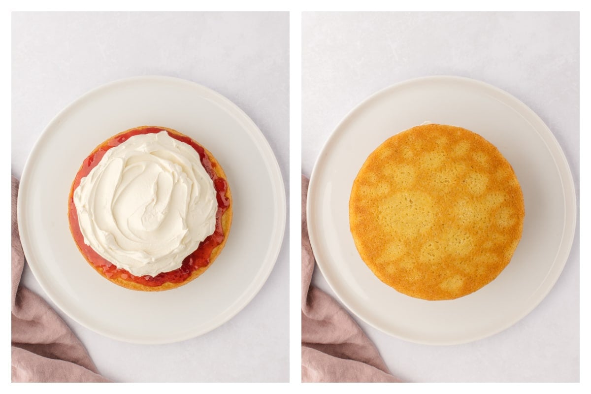 Whipped cream spread over strawberry jam on cake next to top layer on cake. 