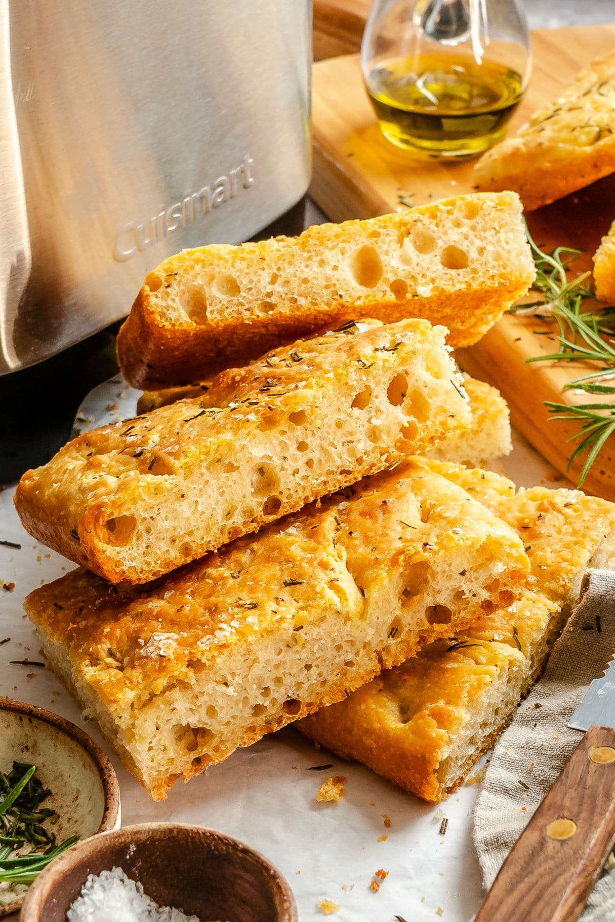 Pieces of focaccia next to a bread machine. 