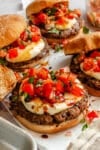 Bruschetta burgers on parchment paper.