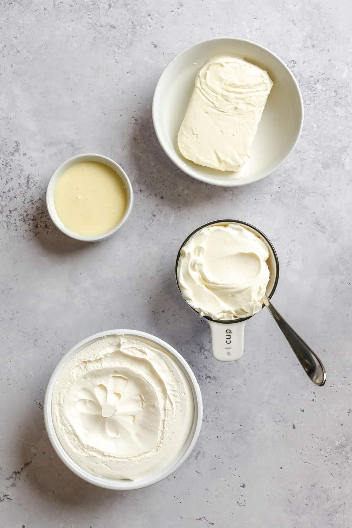 Ingredients for cheesecake dip in dishes.