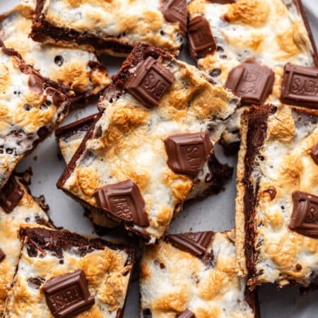 Overlapping s'mores brownies on a plate.