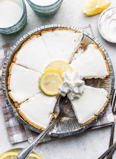 A frozen lemonade pie with a slice removed.