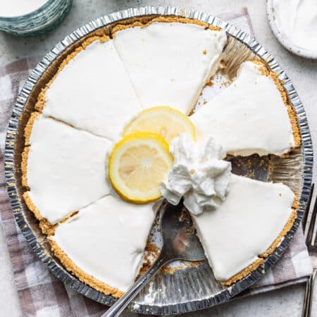 A frozen lemonade pie with a slice removed.