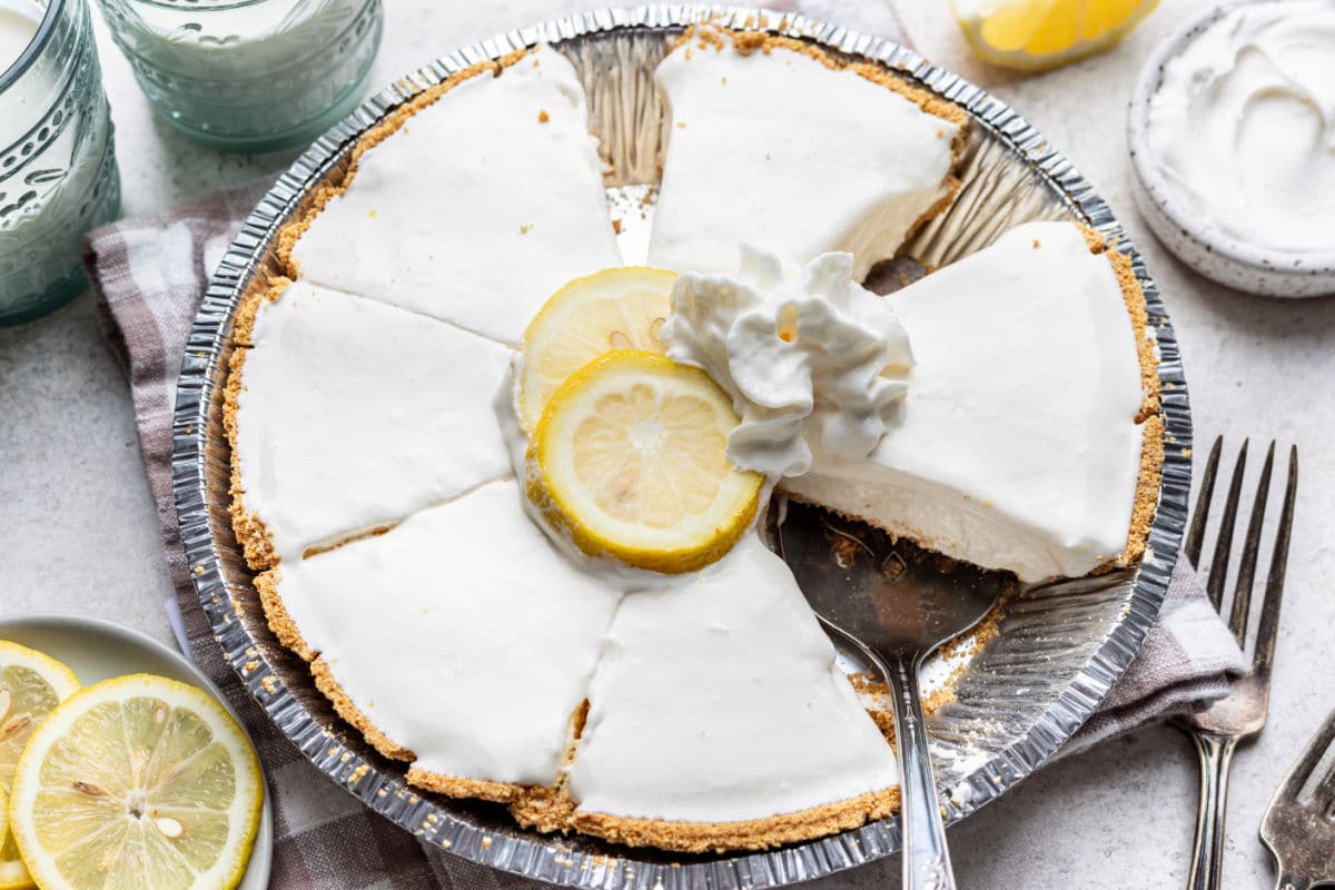 A sliced frozen lemonade pie in the pie tin.