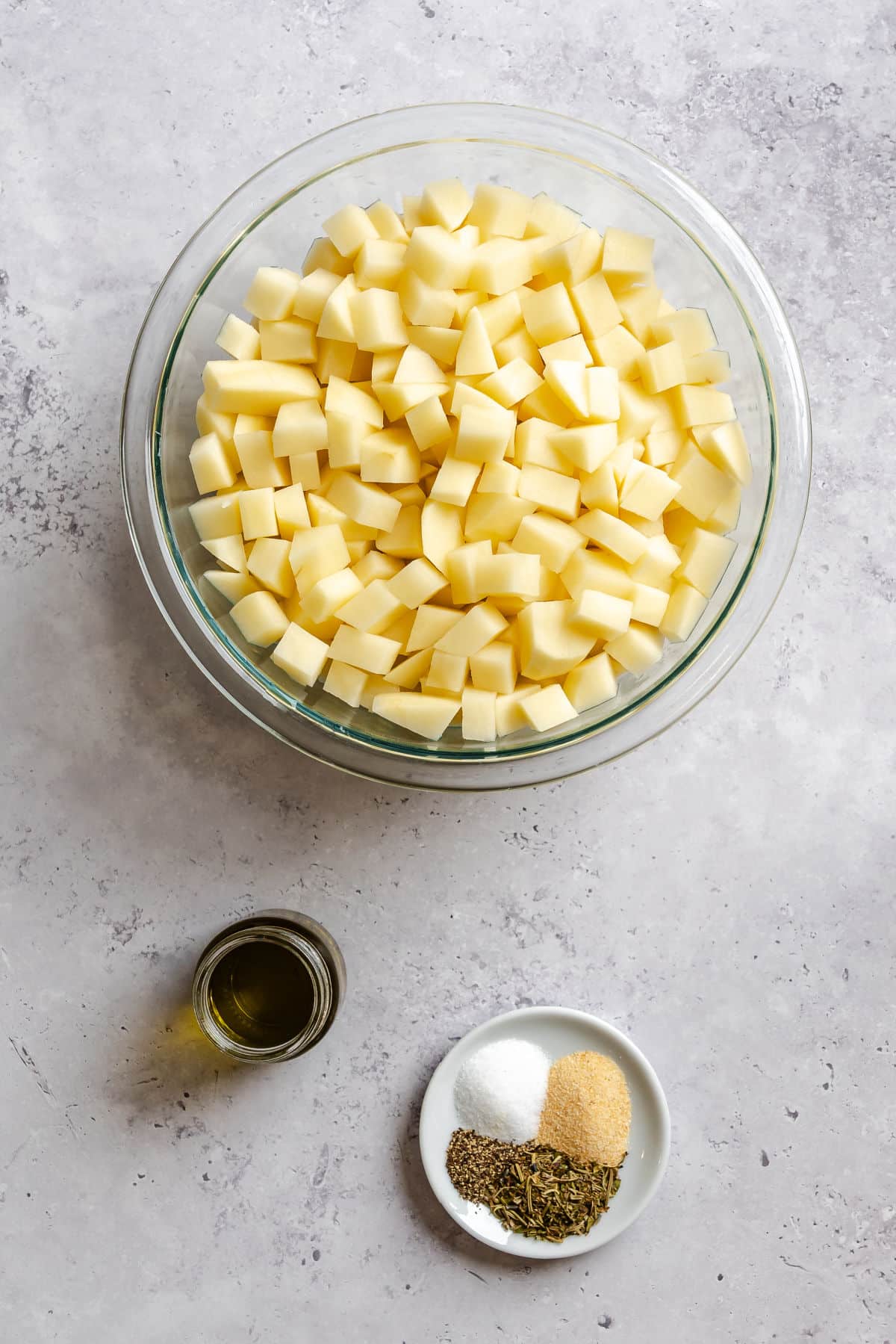 Ingredients for roast potatoes in dishes.