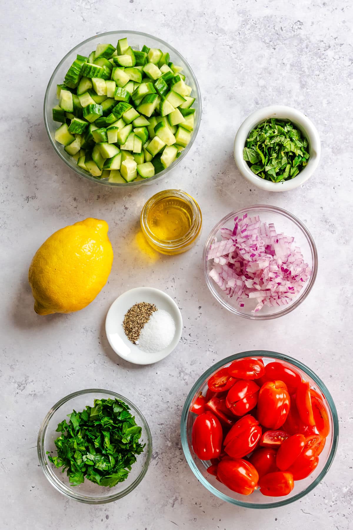 Ingredients for shirazi salad in bowls.