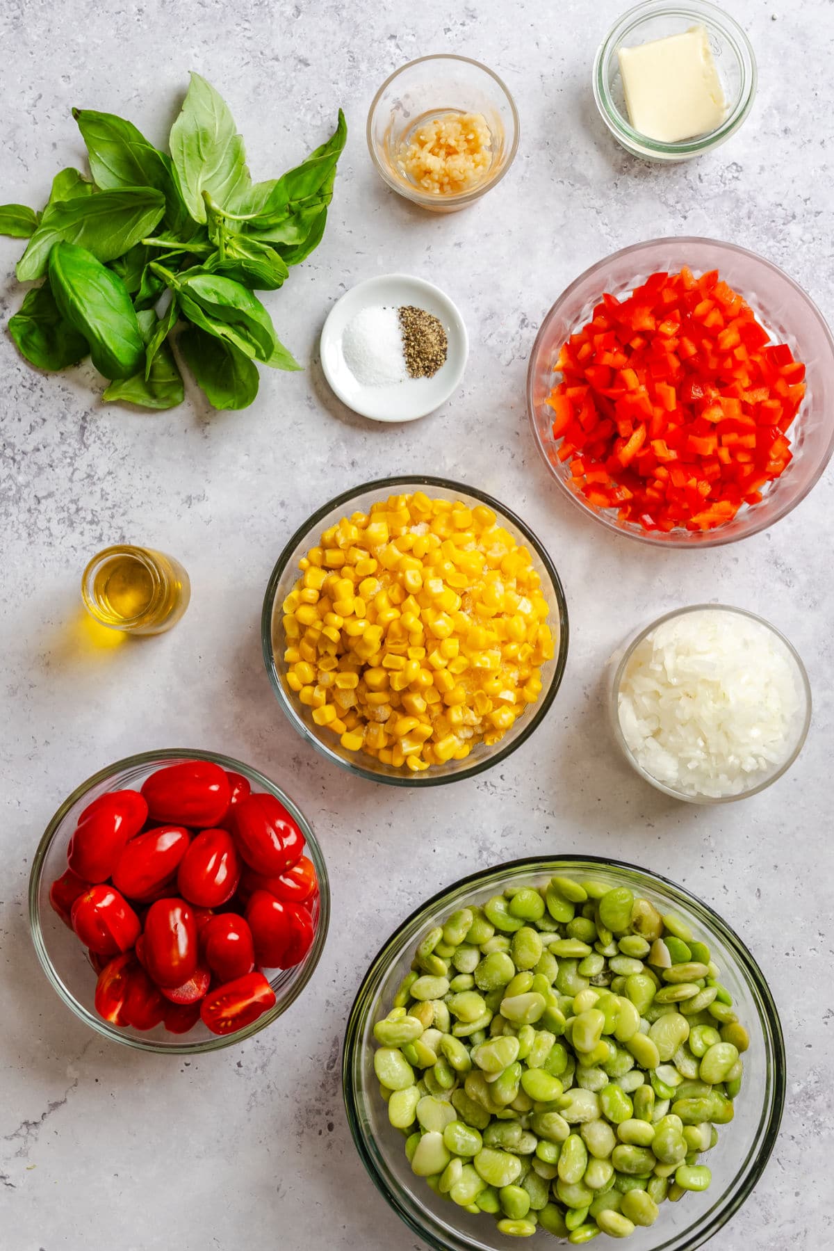 Ingredients for summer succotash in dishes.