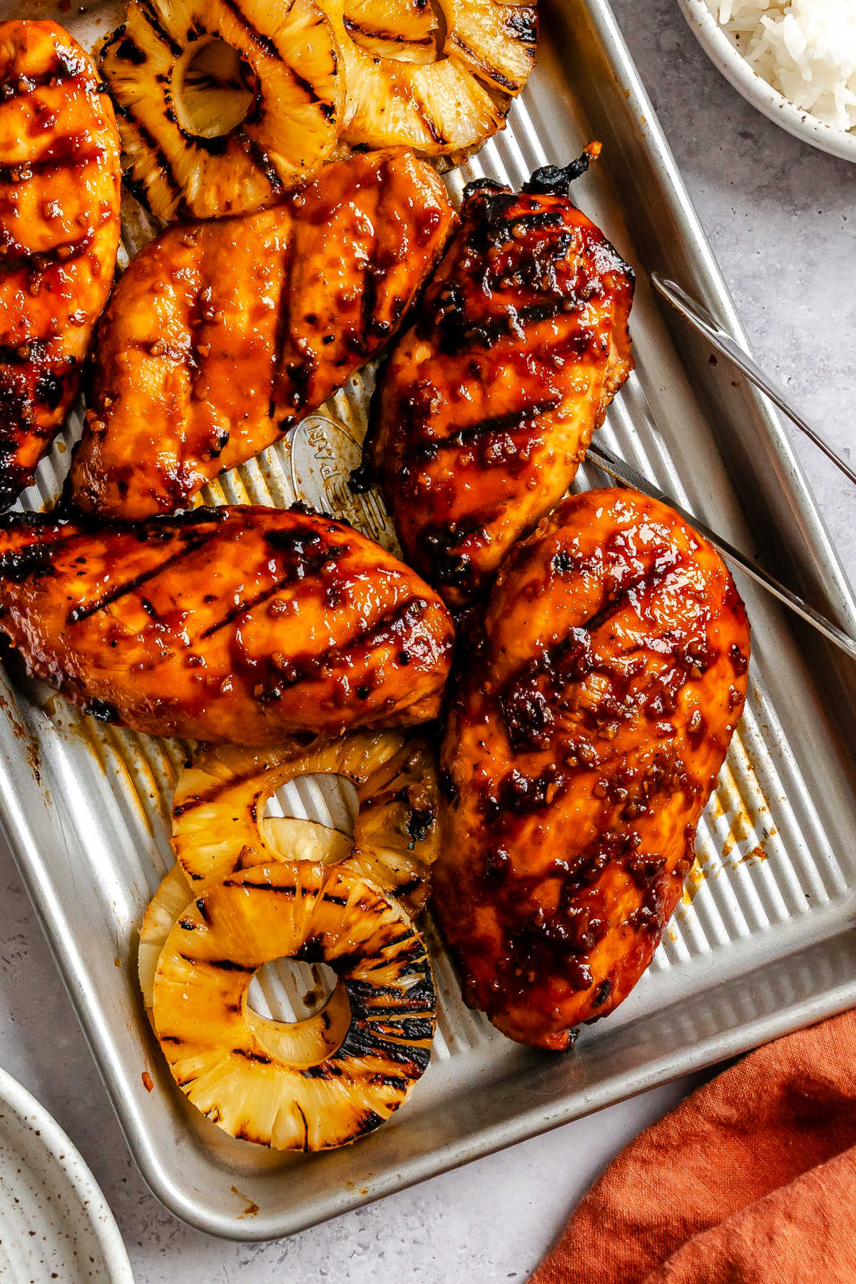 A tray of grilled huli huli chicken and pineapple.