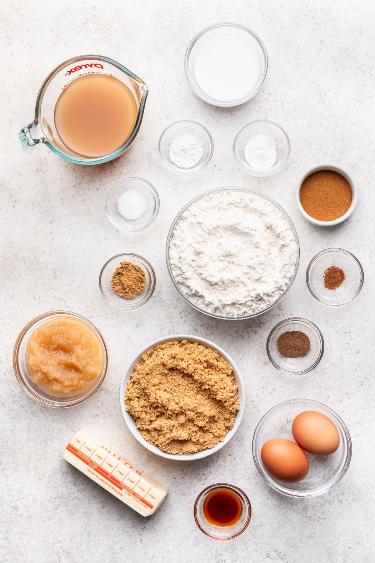 Ingredients for apple cider cake in dishes.