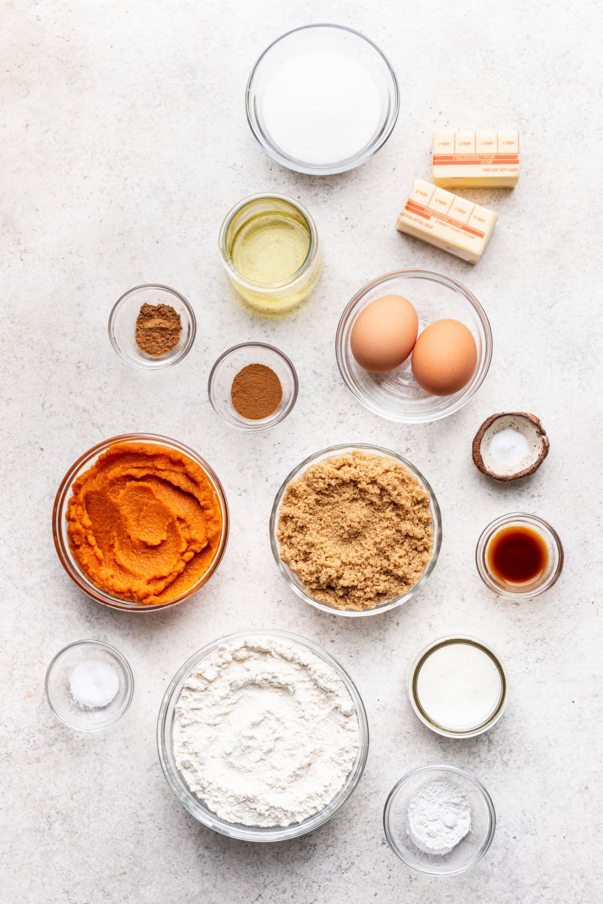 Ingredients for baked pumpkin cake donuts in dishes.
