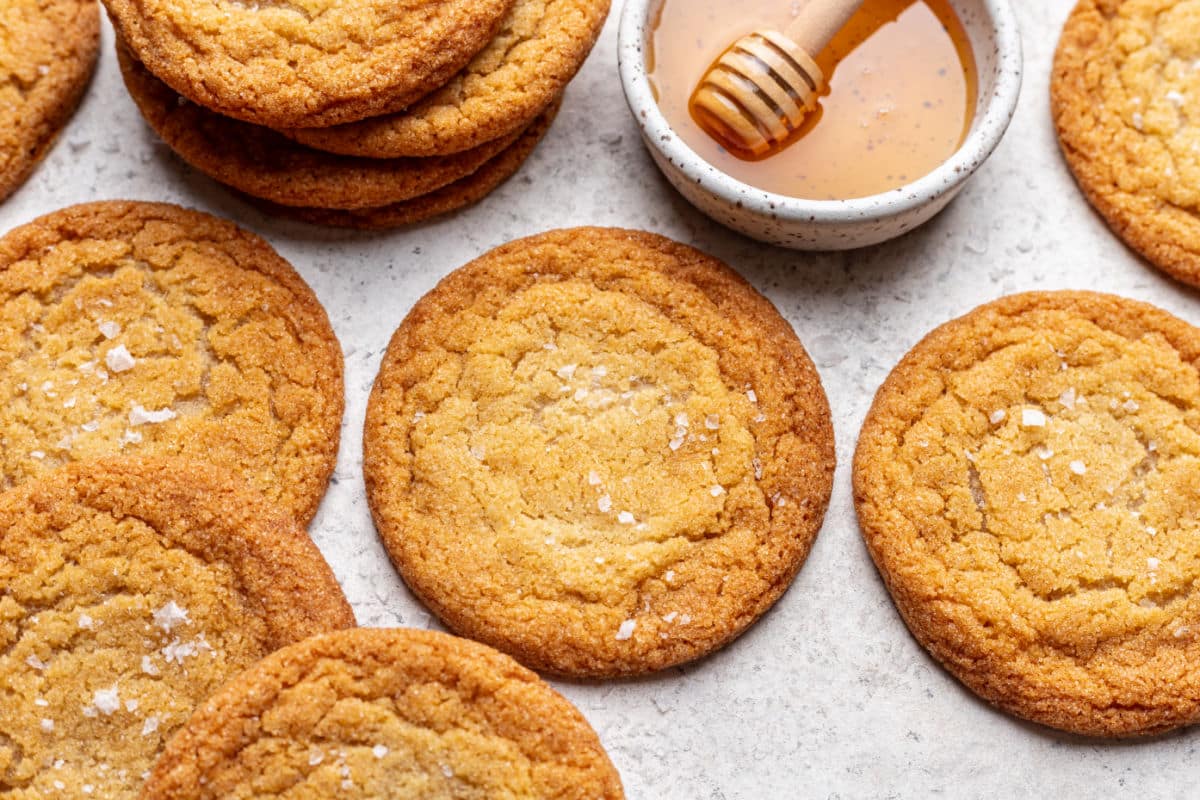 Honey cookies next to a dish of honey.