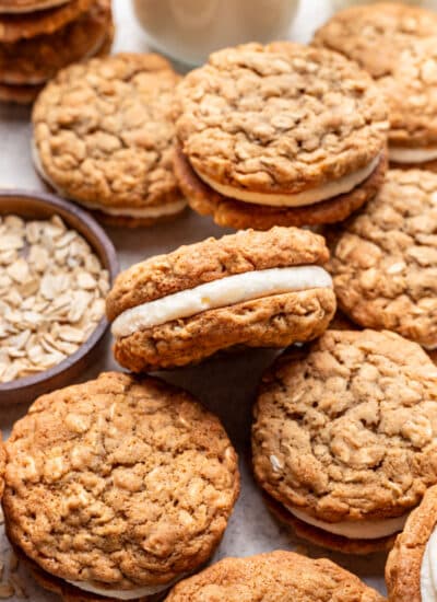 One homemade oatmeal cream pie on its side on top of other oatmeal cream pies.